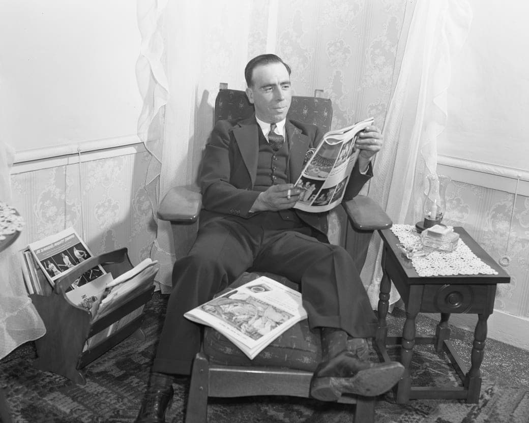 A fisherman reading at home with his feet up, Provincetown, Massachusetts, 1942